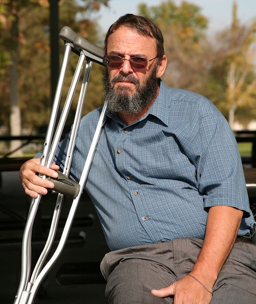 Bigstock_Older_Gentleman_Holding_Crutch_1035467